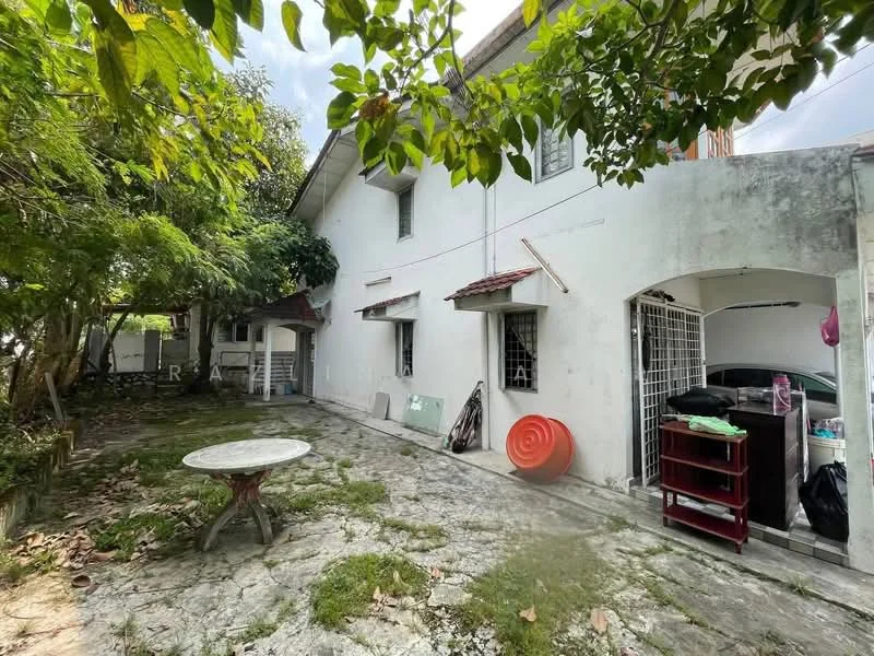 Exterior type: detached bungalow; features: white painted facade, single-storey, stone-paved walkway, mature trees, outdoor seating area with table, garden space, car porch, visible storage area, gravel landscaping; style: traditional.
