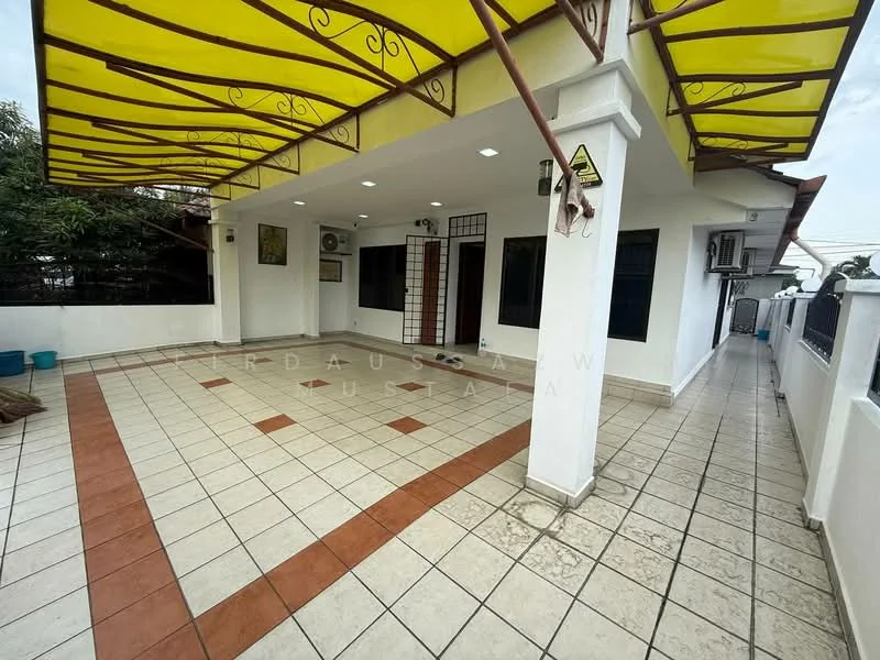 Exterior type: detached bungalow; features: yellow awning with decorative pattern, tiled flooring with alternating colors, exposed concrete walls, wall-mounted split AC unit, multiple entry points, outdoor lighting fixtures, surrounding greenery, fenced perimeter; style: modern.