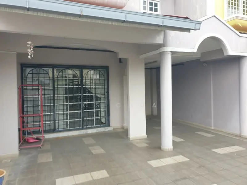 Exterior features: covered porch, grey painted walls, tiled flooring, arched entryway, metal security grille, columns supporting the roof, staircase visible in background, open space, outdoor lighting fixture; style: modern.