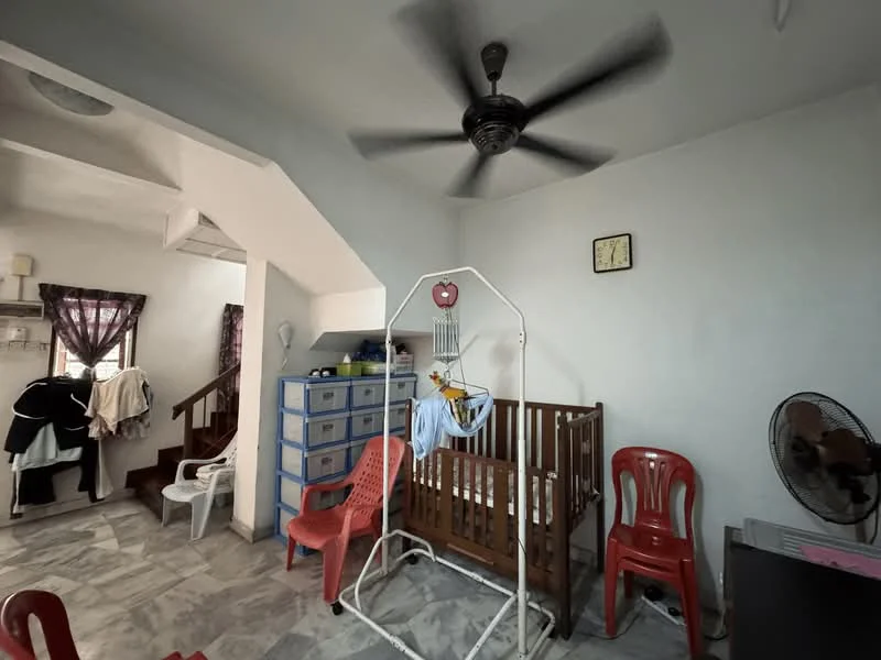 Room features: ceiling fan, white painted walls, marble tile flooring, wooden staircase, wooden crib, red plastic chairs, wall clock, window with sheer curtains, blue storage cabinet, standing fan; style: minimalist.