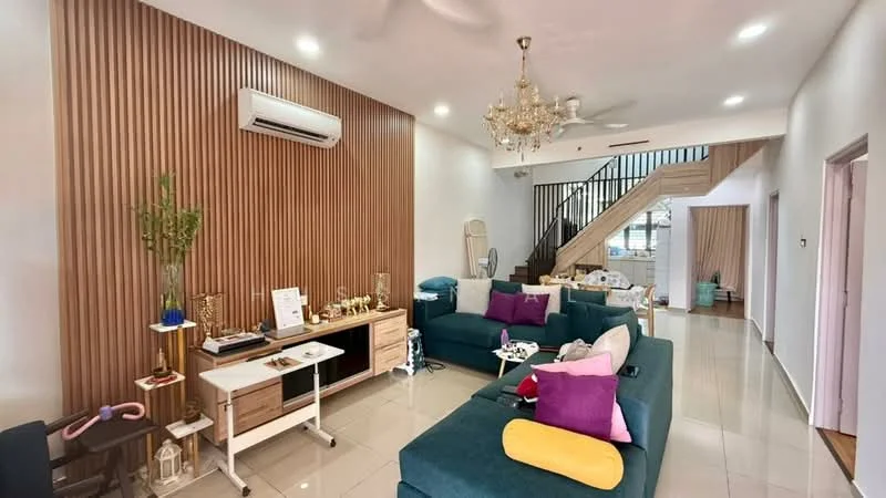 Living features: 3-seater fabric sofa in teal, 2-seater fabric sofa in grey, decorative cushions in various colors, chandelier, 5-blade ceiling fan, wooden accent wall, white painted walls, ceramic tile flooring, wall-mounted air conditioning unit, coffee table, side table, decorative plants, staircase in background; style: modern.
