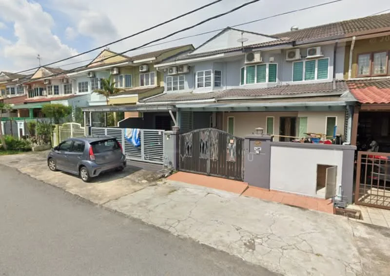 Exterior type: linked terrace house; features: two-storey linked terrace, grey painted facade, white window frames, multiple wall-mounted split AC units, gated entrance, paved driveway, front yard with low fence, car parked in driveway, adjacent houses visible, street view with asphalt road; style: modern.