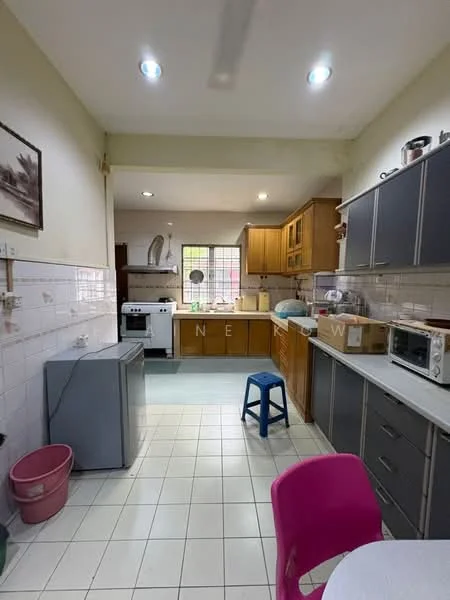 Kitchen features: brown wooden cabinetry, white tiled backsplash, grey countertop, single-bowl stainless-steel sink, chrome pull-down faucet, freestanding gas stove, built-in microwave, refrigerator, white tiled flooring, window with grid pattern, ceiling lights, plastic stool, pink waste bin, round dining table with pink chair; style: modern.