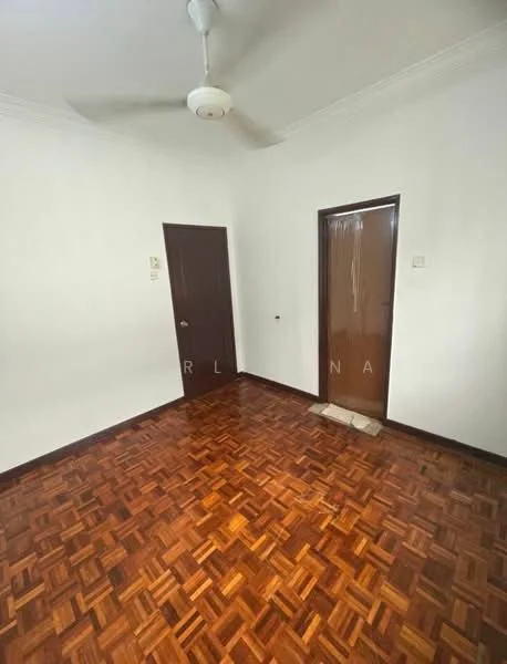 Room features: wooden flooring, white painted walls, ceiling fan, two doors, no visible windows, plain ceiling, baseboards.