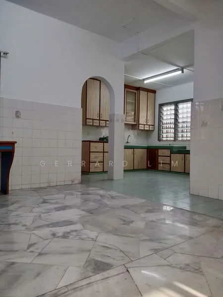 Kitchen features: marble flooring, white tiled walls, wood cabinetry, green countertop, single-bowl stainless-steel sink, chrome pull-down faucet, window with grid pattern, built-in cabinets, kitchen island, archway entrance.