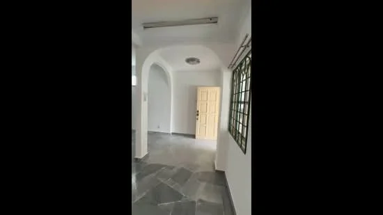 Room features: white painted walls, grey stone flooring, arched doorway, ceiling light fixture, window with grid pattern, door with panel design; style: modern.