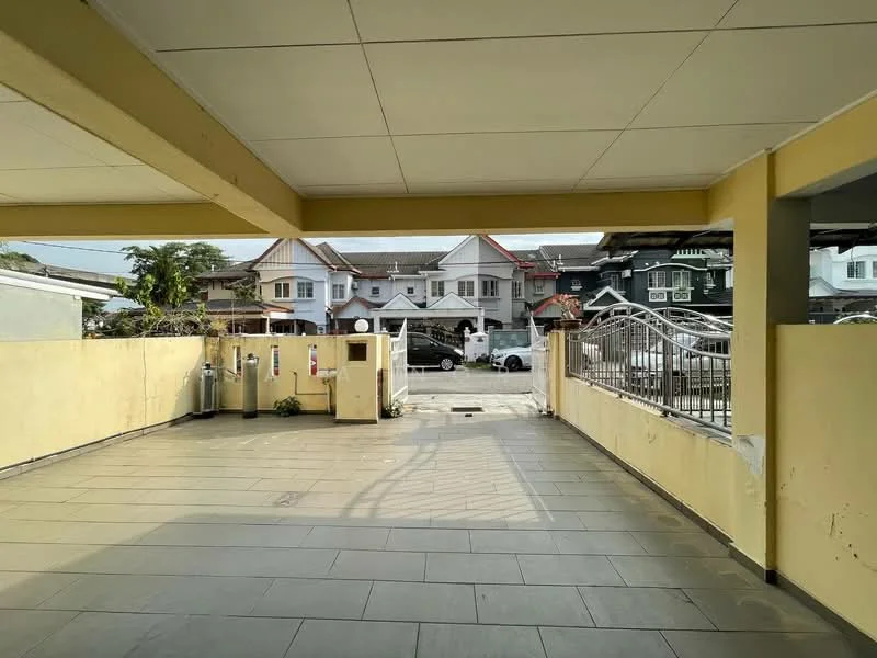 Exterior type: linked terrace house; features: paved flooring, yellow painted walls, covered car porch, metal gate, surrounding residential houses, open parking area, landscaped garden, fence, driveway; style: modern.