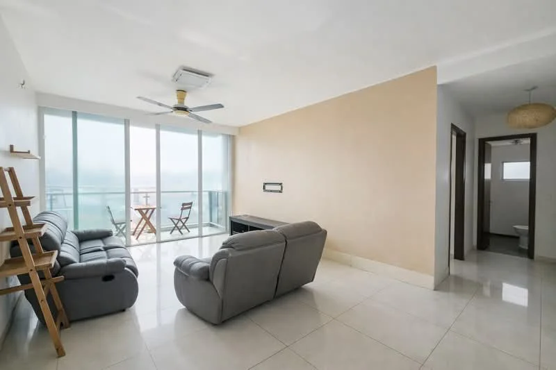 Living features: 2-seater leather sofa in grey, 3-seater leather sofa in grey, coffee table, floor-to-ceiling windows, 5-blade ceiling fan with light, white painted walls, cream tiled flooring, decorative wall shelf, balcony view; style: modern; view: city. Room features: doorway leading to bathroom, light-colored walls, neutral flooring.