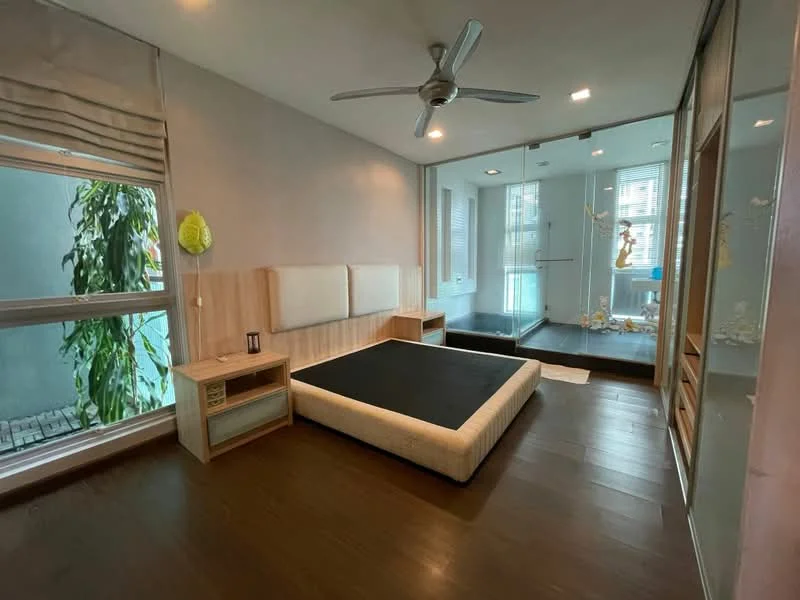 Bedroom features: wooden flooring, light grey painted walls, ceiling fan, large window with sheer curtains, built-in wardrobe with sliding doors, bed frame without mattress, nightstand, decorative plant, glass partition, natural light from window; style: modern; view: garden.