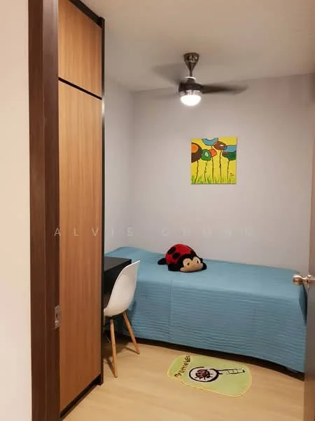 Bedroom features: single bed with blue bedding, wooden wardrobe with sliding doors, white study desk, white chair, ceiling fan with light, light-colored laminate flooring, decorative rug with cartoon design, wall painted in light color, stuffed toy on bed; style: modern.