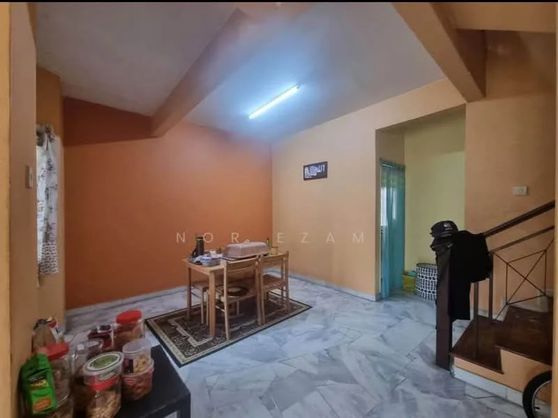 Dining features: orange painted walls, cream painted walls, marble tile flooring, wooden staircase, dining table with four chairs, area rug, window with sheer curtains, decorative wall art. Room features: light fixture, open space, corner with laundry basket.