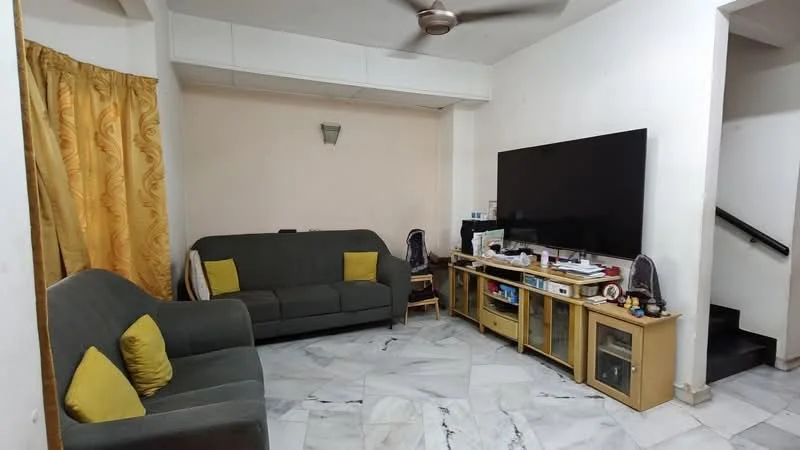 Living features: grey fabric sofa, 2-seater sofa, yellow accent cushions, marble flooring, wall-mounted TV, wooden TV console, decorative items on console, ceiling fan, yellow curtains, wall sconce, light-colored walls, staircase in background; style: modern.
