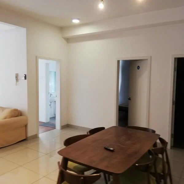 Room features: white painted walls, tile flooring, recessed downlights, dining table with wooden surface, green upholstered chairs, doorway leading to bathroom, doorway leading to another room, sofa in beige fabric.