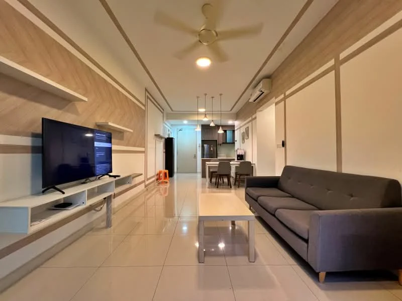 Living features: grey fabric sofa, coffee table, wall-mounted TV, white TV console, recessed ceiling lights, ceiling fan, cream painted walls, glossy tile flooring, open layout to dining area, decorative wall paneling; style: modern.
