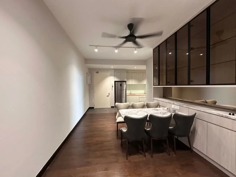 Dining features: dining table with marble top, upholstered dining chairs, 5-blade ceiling fan with light, wooden flooring, white painted walls, recessed downlights, built-in cabinetry, stainless-steel fridge, open layout to kitchen, large window with black frame; style: modern. Kitchen features: white cabinetry, stainless-steel appliances, countertop with backsplash, open layout to dining area; style: modern.