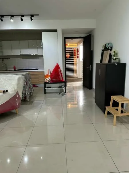 Living features: white painted walls, glossy tile flooring, recessed downlights, sofa covered with plastic, coffee table, TV console, wooden stool, black cabinet, open doorway, kitchen area visible in background, decorative items on cabinet; style: modern.
