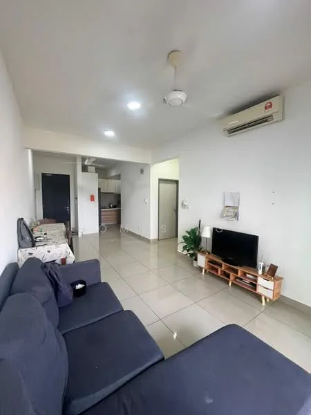 Living features: grey fabric sofa, flat-screen TV on wooden stand, wall-mounted air conditioning unit, recessed ceiling lights, white painted walls, glossy ceramic tile flooring, ceiling fan, open layout to kitchen, decorative plant in pot; style: modern. Kitchen features: open kitchen layout, wooden cabinetry, stainless-steel sink, countertop with space for appliances, exposed brick wall, refrigerator visible in background; style: modern.