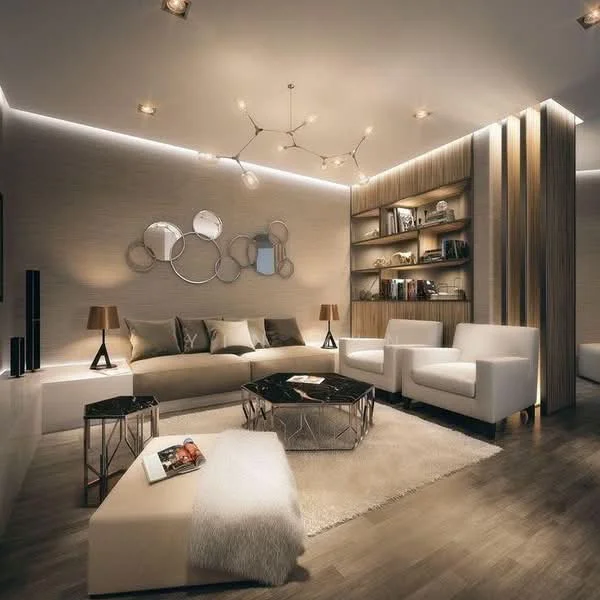 Living features: L-shape sectional sofa in white, two white armchairs, black coffee table with geometric design, side tables with lamps, decorative wall shelves with books, wall-mounted mirrors in circular shapes, recessed LED lighting, wood panel accent wall, plush area rug, wood flooring, decorative wall art, modern light fixture with multiple arms; style: modern.