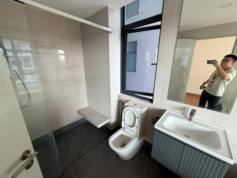 Bathroom features: walk-in shower with glass enclosure, chrome handheld shower, wall-mounted toilet, single-sink vanity with grey cabinet, mirror above sink, tile cladding on walls, grey tile flooring, window for natural light; style: modern.