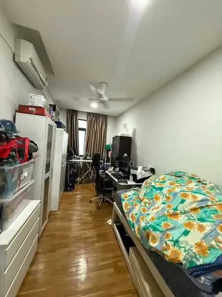 Bedroom features: wooden flooring, white painted walls, 5-blade ceiling fan, window with curtains, single bed with floral bedding, study desk with chair, black office chair, plastic storage drawers, black cabinet, computer monitor, laptop, clothes on bed.
