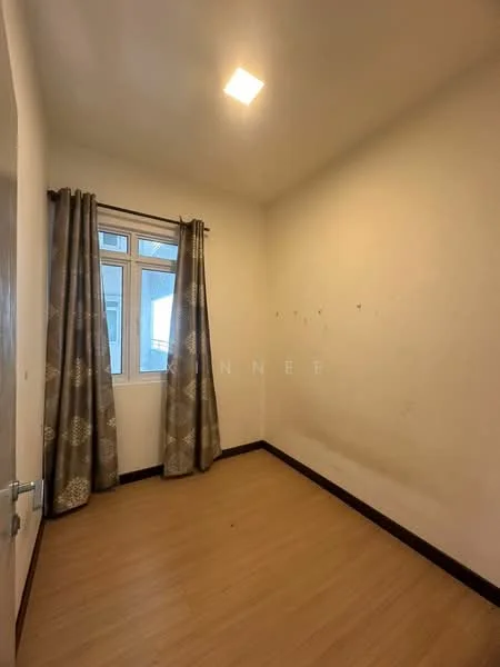 Room features: light wood laminate flooring, white painted walls, single window with sheer curtains, two-tone curtains, ceiling light fixture, corner of room with visible wall marks.