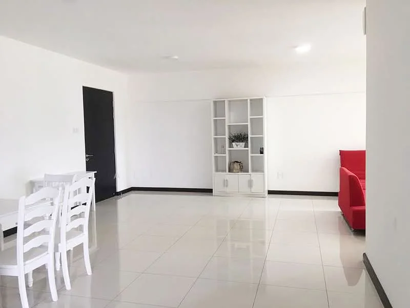 Living features: white painted walls, glossy tile flooring, recessed downlights, red fabric sofa, white dining table with chairs, white shelving unit, decorative plant on shelf, black door; style: modern.
