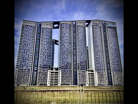 Exterior type: high-rise condominium; features: glass curtain wall, blue tinted windows, recessed balconies, modern architectural design, multiple towers, landscaped grounds, surrounded by greenery; style: modern.