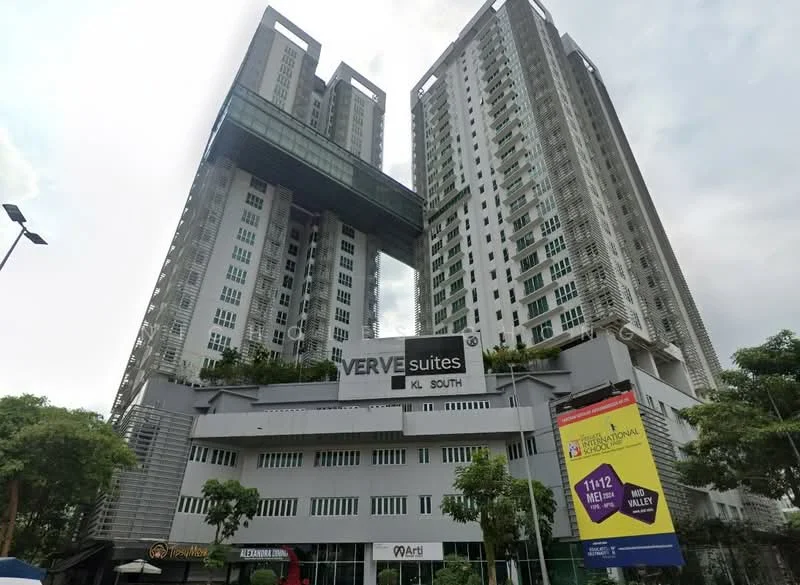 Exterior type: high-rise condominium; features: glass curtain wall, white painted facade, recessed balconies, multiple storeys, landscaped terrace, signage visible, surrounded by greenery, modern architectural design; style: modern.