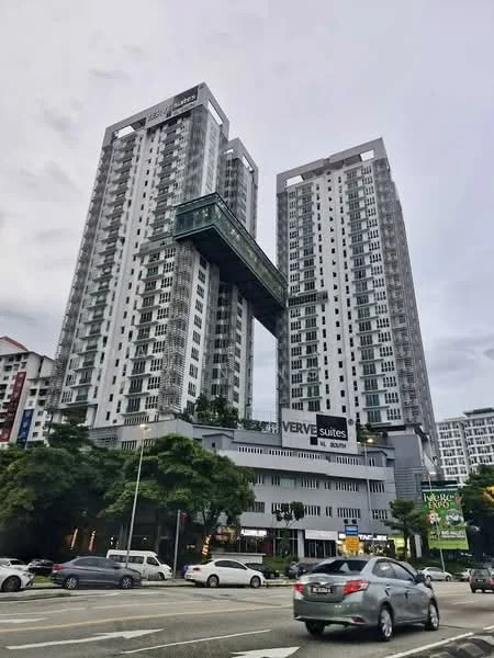 Exterior type: high-rise condominium; features: glass curtain wall, white painted facade, recessed balconies, projecting balconies, double-volume main lobby, landscaped entrance with greenery, signage for VERVE Suites, surrounded by urban context, multiple storeys, modern architectural design; style: modern.