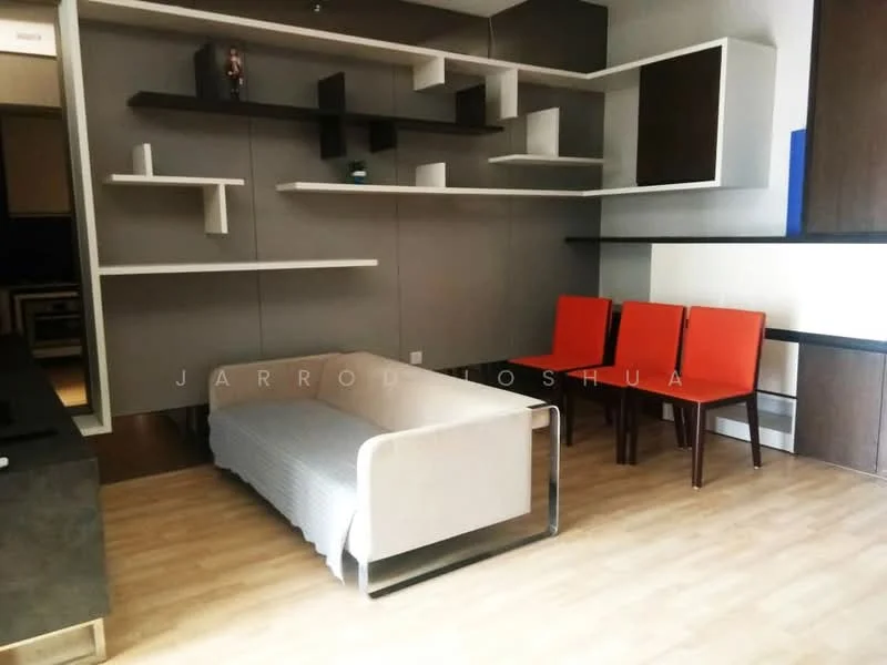 Living features: light wood flooring, grey painted walls, white shelving units on walls, white sofa with throw blanket, 4 red dining chairs, decorative figure on shelf, minimalist design, open layout; style: modern.