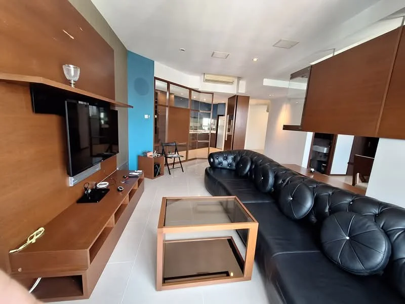 Living features: black leather sectional sofa, glass coffee table, wooden TV console, wall-mounted TV, built-in shelving unit, light-colored tiled flooring, blue accent wall, recessed ceiling lights, air conditioning unit, decorative wall paneling; style: modern.