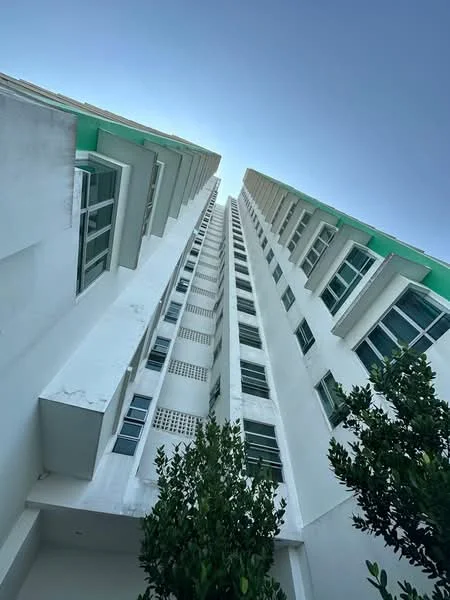 Exterior type: high-rise condominium; features: white painted facade, glass windows, green accent on roof, vertical fins, approximately 20-storey high-rise, surrounded by trees; style: modern.