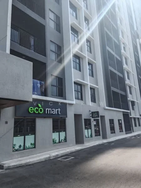 Exterior type: mid-rise condominium; features: grey concrete facade, glass curtain wall, projecting balconies, commercial space at ground level, signage for eco mart, parking area in front, multiple storeys visible, windows with black frames; style: modern.