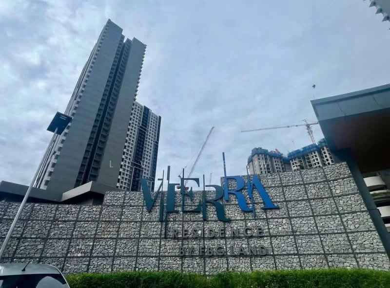 Exterior type: high-rise condominium; features: stone cladding facade, glass curtain wall, signage with 'Vierra Residence', surrounding construction cranes, manicured landscaping, modern architectural design; style: modern.