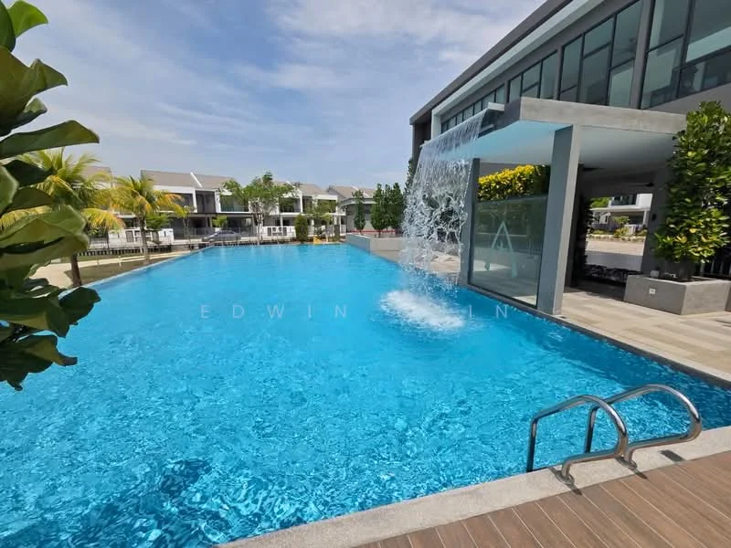 Exterior type: swimming pool deck; features: infinity pool, waterfall feature, surrounded by tropical landscaping, decking area with wooden finish, poolside loungers, manicured greenery, modern architectural design, clear blue water; style: modern.