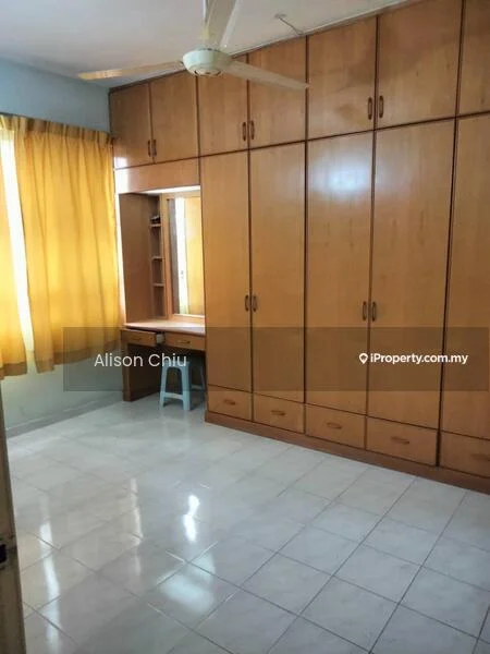 Bedroom features: built-in wooden wardrobe, study desk with chair, cream tiled flooring, yellow curtains, ceiling fan, white walls, natural light from window.