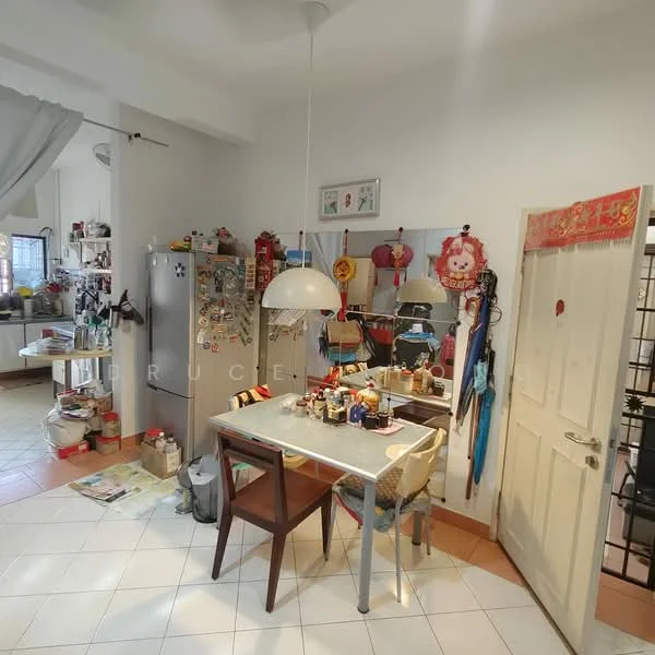 Kitchen features: white walls, tile flooring, round pendant light, dining table with four chairs, stainless-steel fridge, open shelving, decorative wall mirror, various kitchen appliances, wall-mounted storage, door with handle, kitchen utensils on table, colorful wall decorations, multiple items on floor.