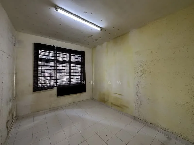 Room features: white painted walls with stains, black window with horizontal slats, white tiled flooring, fluorescent ceiling light, corner window, no visible furniture, exposed ceiling with stains.