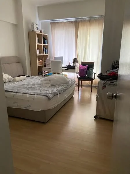 Bedroom features: queen-size bed with light-colored bedding, wooden flooring, large window with sheer curtains, bookshelf with open shelving, chair with cushion, small table, suitcase, decorative pillows, wall-mounted mirror.