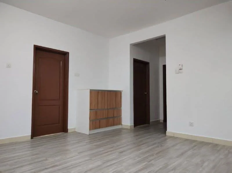 Room features: light grey laminate flooring, white painted walls, wooden door with brown finish, built-in cabinet with wood and white finish, doorway leading to another room, doorway leading to hallway, neutral ceiling, baseboards; style: modern.