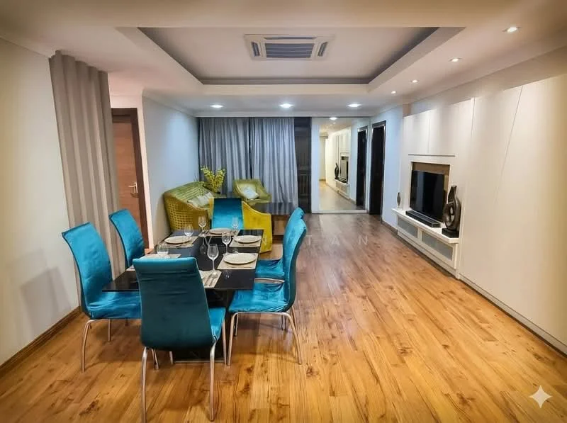 Dining features: 6-seater dining table, black glass tabletop, metal dining chairs with turquoise upholstery, wooden flooring, recessed ceiling lights, air conditioning unit, decorative plant in vase, wall-mounted TV unit, built-in cabinetry with white finish, curtains, open layout to living area; style: modern.