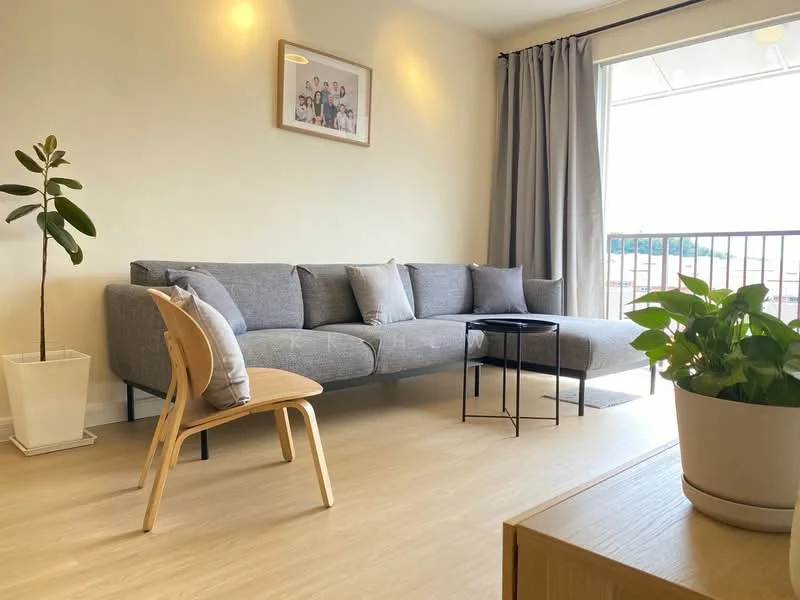 Living features: L-shape sectional sofa in grey, coffee table, wooden chair, potted plant, floor-to-ceiling window, curtains, light-colored walls, laminate flooring, framed artwork on wall; style: modern.