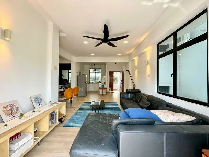Living features: black leather sectional sofa, blue area rug, wooden coffee table, 5-blade ceiling fan with light, wall-mounted TV, large windows with black frames, light-colored walls, laminate flooring, decorative wall sconces, open layout to kitchen, decorative artwork on shelf; style: modern; view: garden.