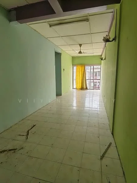 Room features: green painted walls, white tiled flooring, ceiling fan, large window with yellow curtains, doorway leading to another room, exposed ceiling beams, natural light from window.