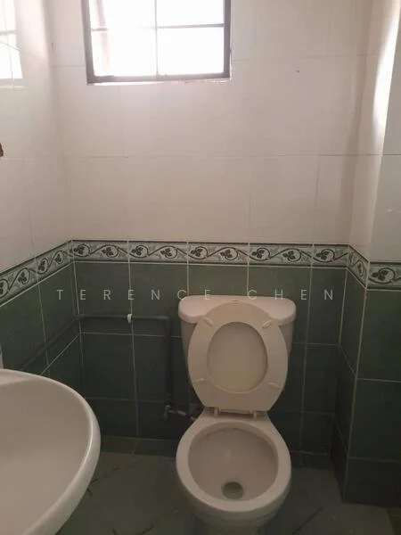 Bathroom features: white toilet, round basin, green tiled walls, white tiled walls, window for natural light, floor tiles with green accents.