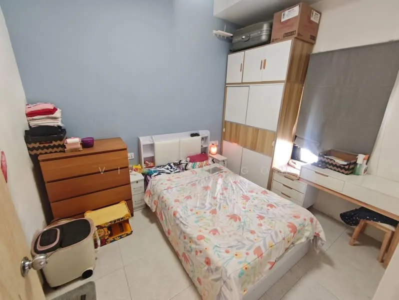 Bedroom features: queen-size bed with floral bedding, wooden bedside table, chest of drawers in wood, built-in wardrobe with white and wood finish, desk with mirror, window with grey curtain, tile flooring, wall-mounted light, suitcases on top of wardrobe, decorative items on desk; style: modern.