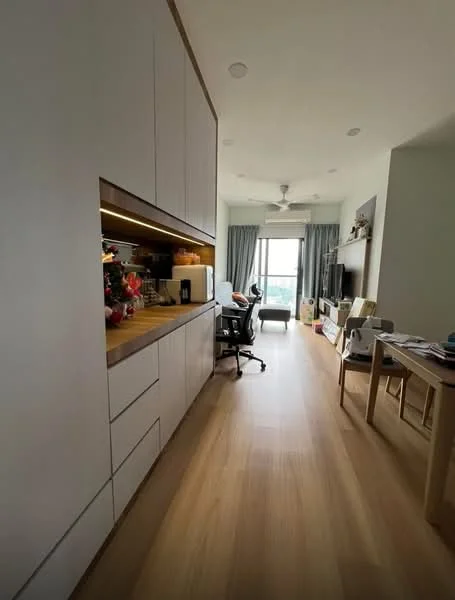 Room features: light wood flooring, white cabinetry with flat-panel design, wood countertop, recessed lighting, ceiling fan, large window with sheer curtains, grey upholstered chair, TV console, decorative items on shelves, work desk with chair, open layout, neutral wall color; style: modern; view: city.