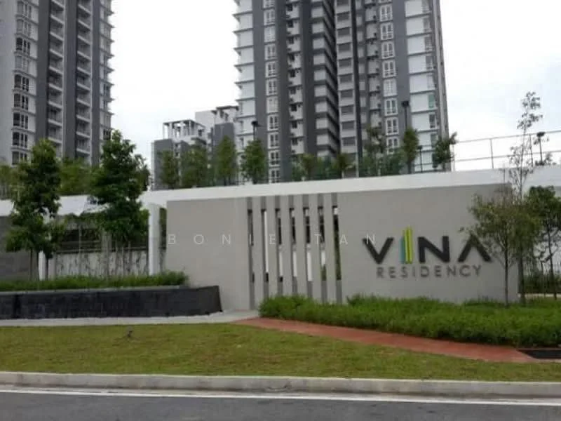 Exterior type: high-rise condominium; features: modern facade with concrete and glass elements, landscaped entrance with greenery, signage with the name 'VINA RESIDENCY', manicured lawn, paved walkway, surrounding high-rise buildings; style: modern.