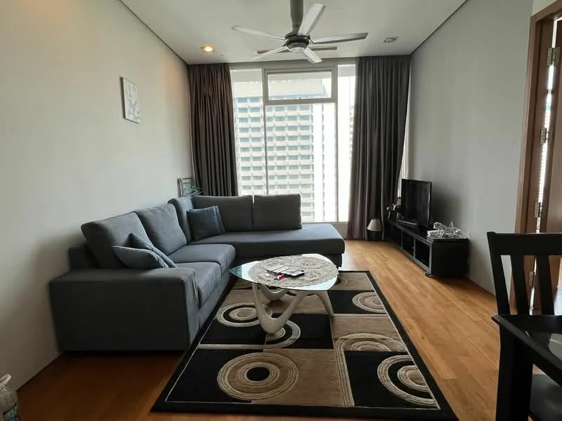 Living features: L-shape sectional sofa in grey, coffee table, area rug with circular pattern, wall-mounted TV, TV console, floor-to-ceiling windows, curtains, wooden flooring, ceiling fan with light; style: modern; view: city.