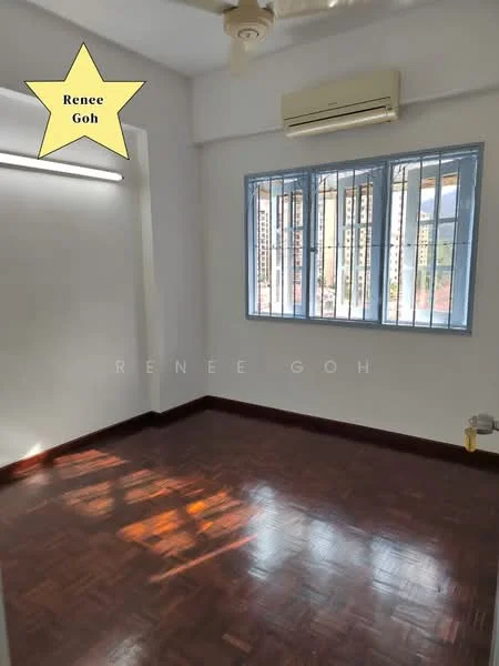Room features: wooden flooring, white painted walls, ceiling fan, wall-mounted split AC, window with metal grille, natural light from window, baseboard, no visible furniture.